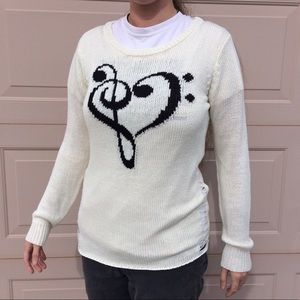 Cream musical sweater.